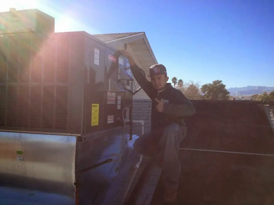 HVAC technician performing AC Tune-Up on a rooftop unit in Onalaska